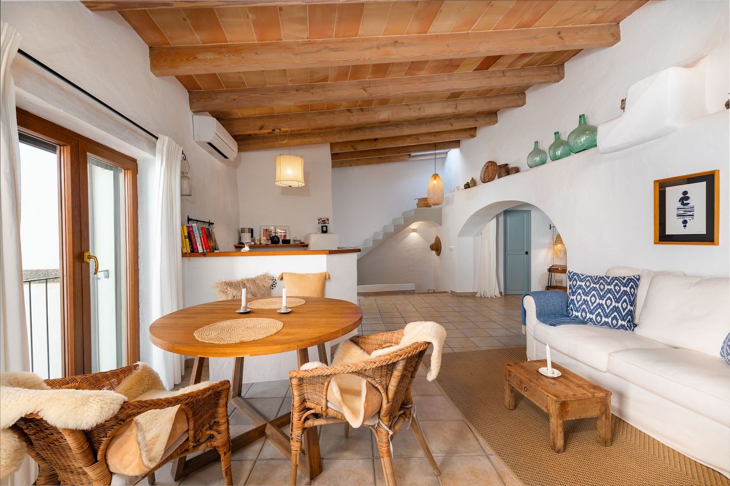 Living and dining with wooden beams area with