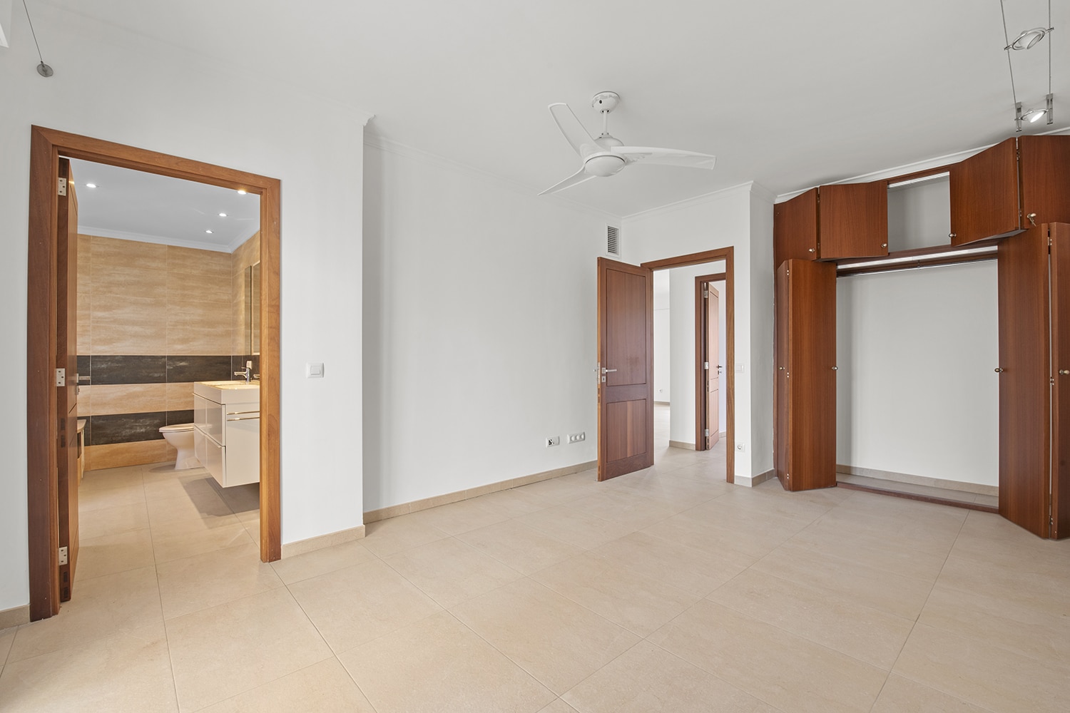 Spacious bedroom with en-suite bathroom and bespoke built-in storage