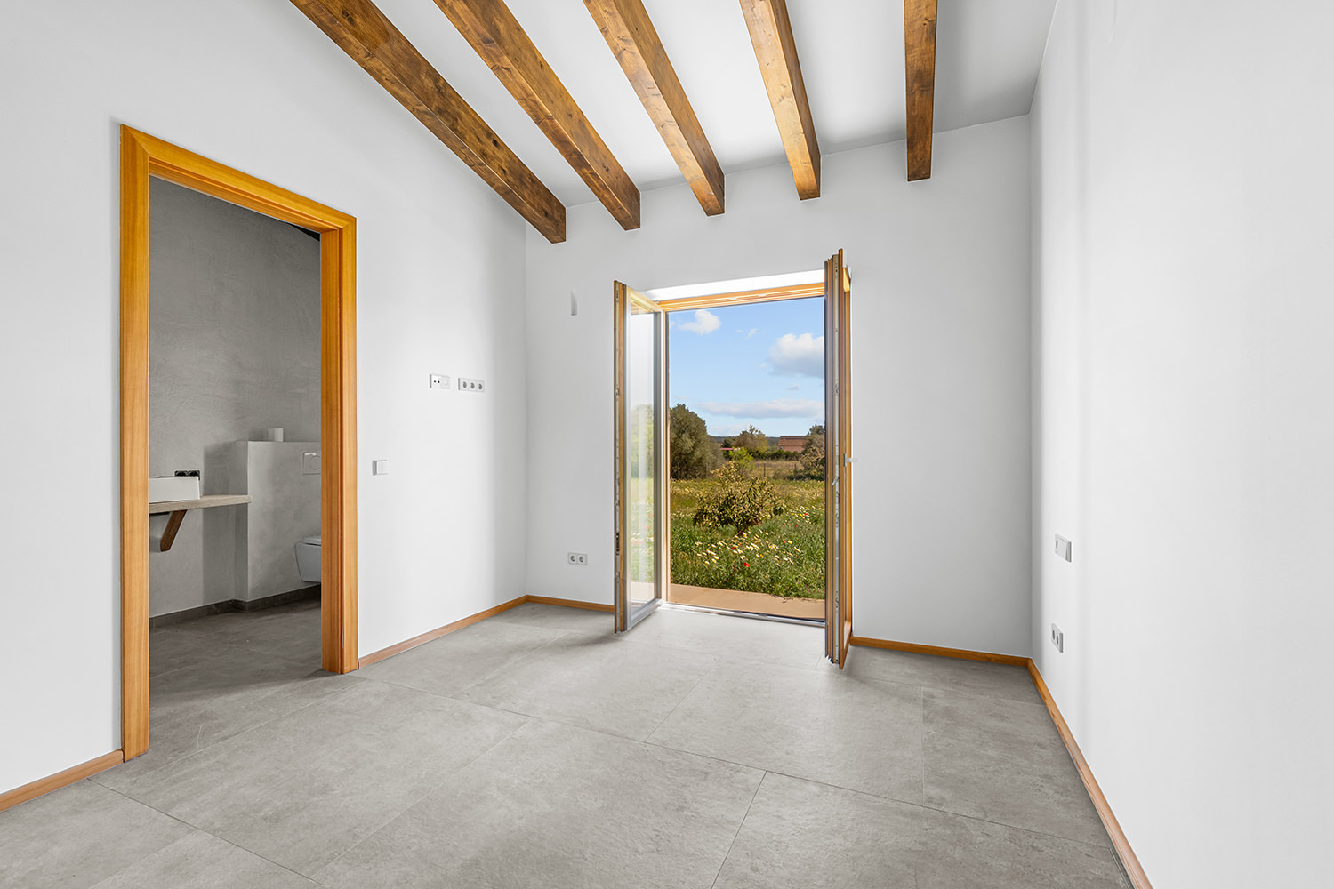 Bright bedroom with terrace access and garden views
