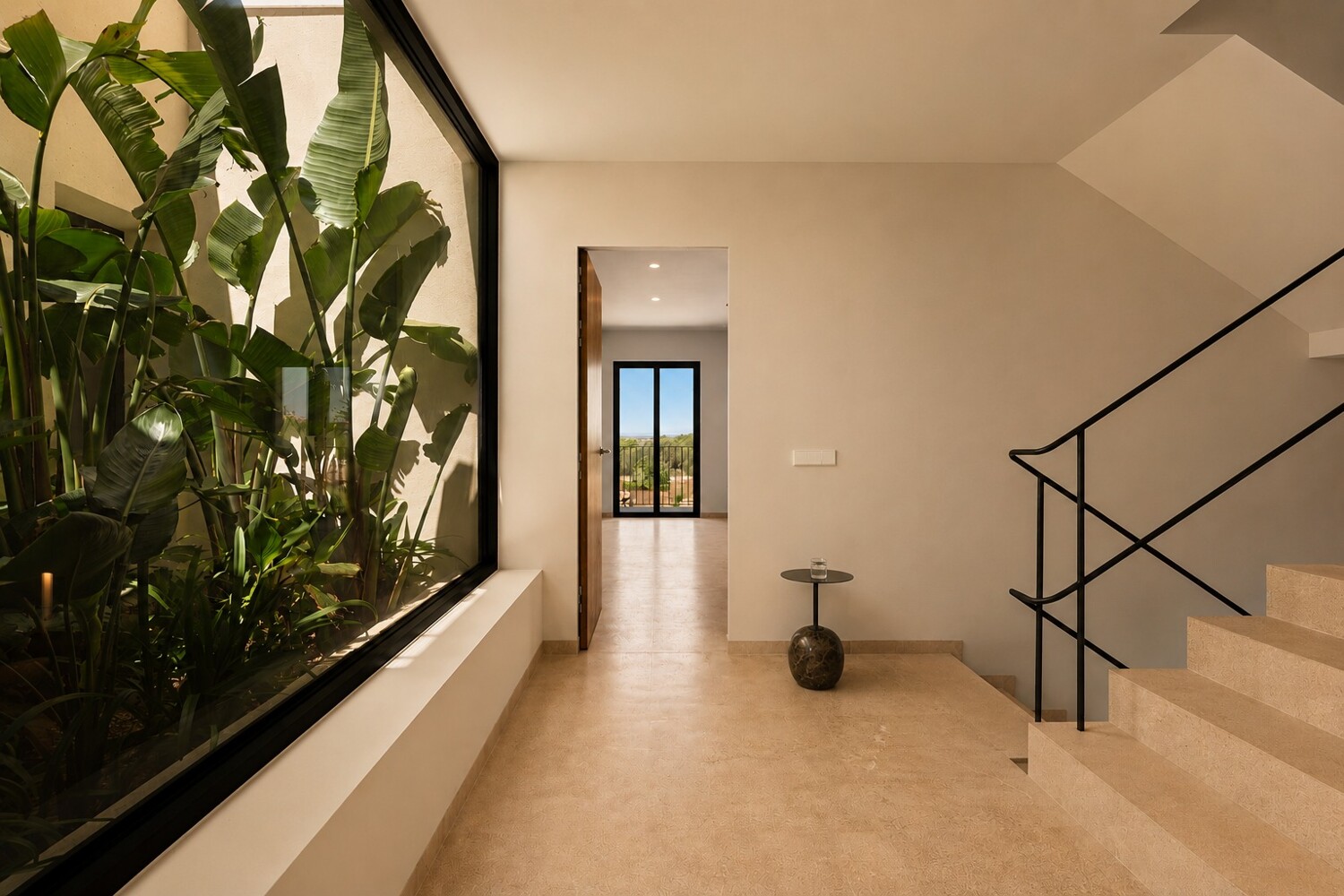 Elegant entrance area with staircase, metal railing and landscaped inner courtyard as an architectural feature