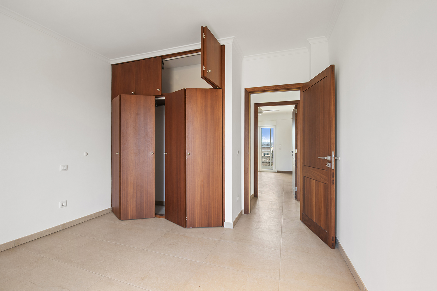 Spacious bedroom with en-suite bathroom and bespoke built-in storage