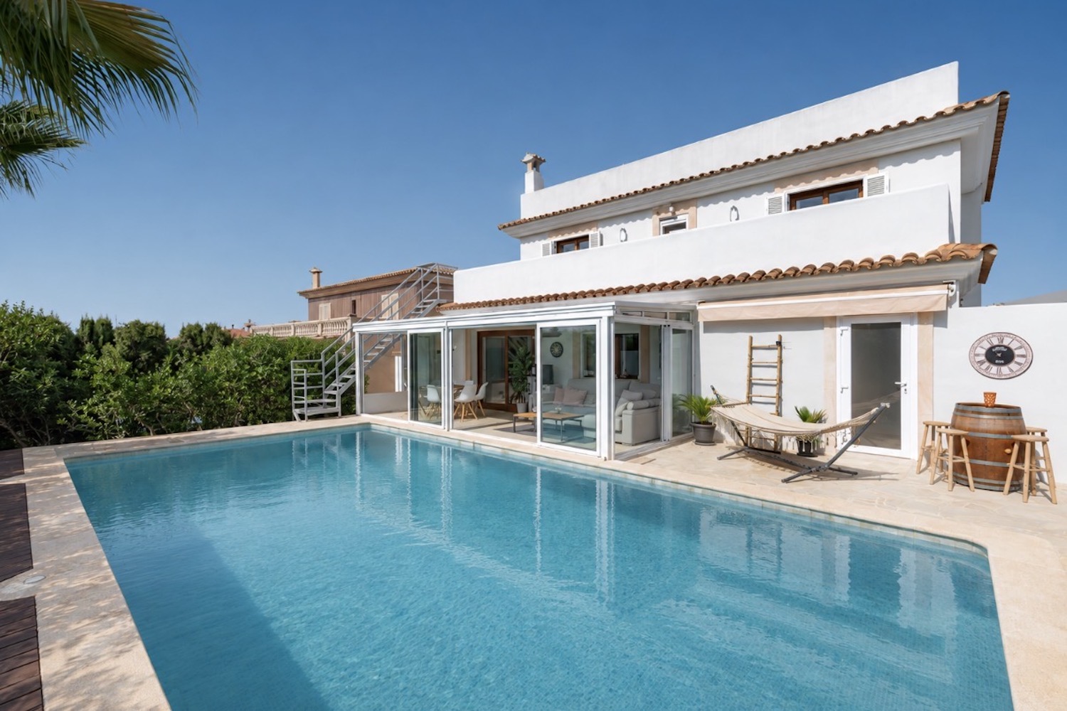 Generous pool area framed by Mediterranean villa architecture