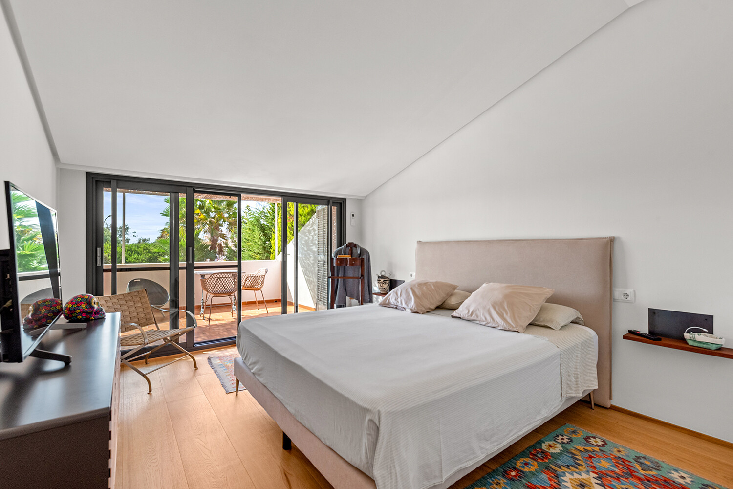 Spacious principal bedroom with direct access to a private covered terrace