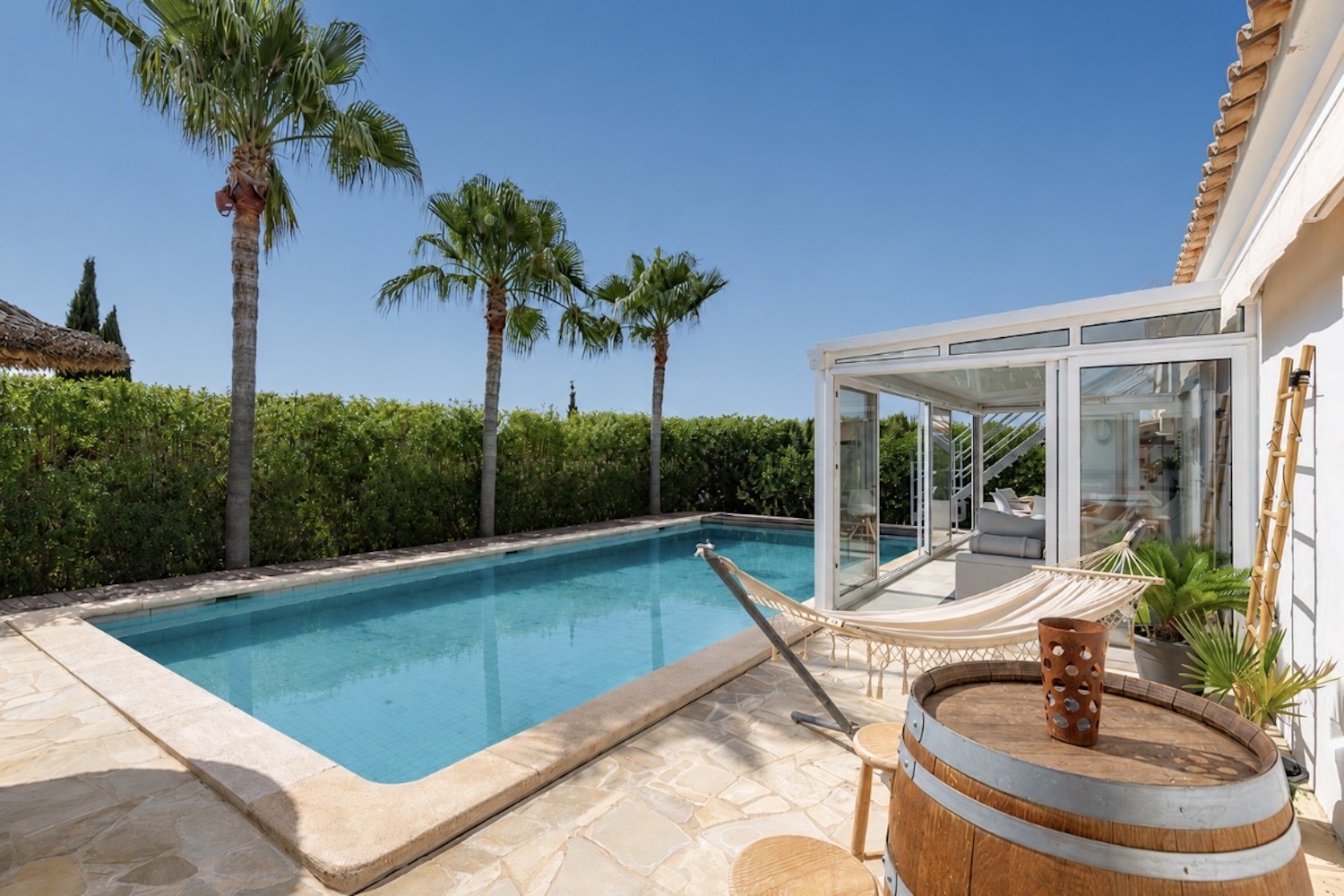 Sunlit pool terrace with elegant lounge area